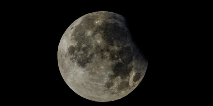 Rare partial lunar eclipse of harvest supermoon delights UK stargazers
